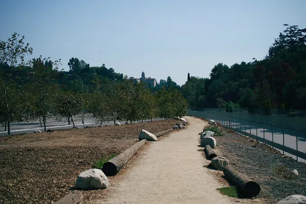 Trail along the Arroyo Seco in Pasadena lined with young trees and log edging
