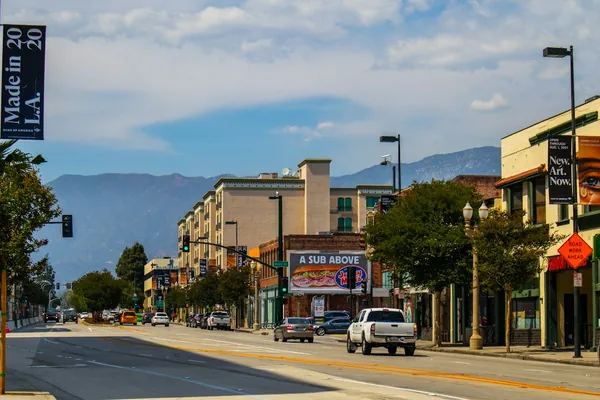 Pasadena street with street trees and the San Gabriel Mountains behind
